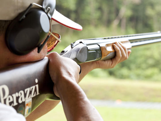 Gentleman with perazzi gun and ear defenders  clay shooting